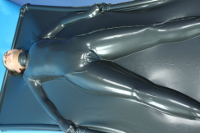 girl in vacbed made from metallic pewter latex