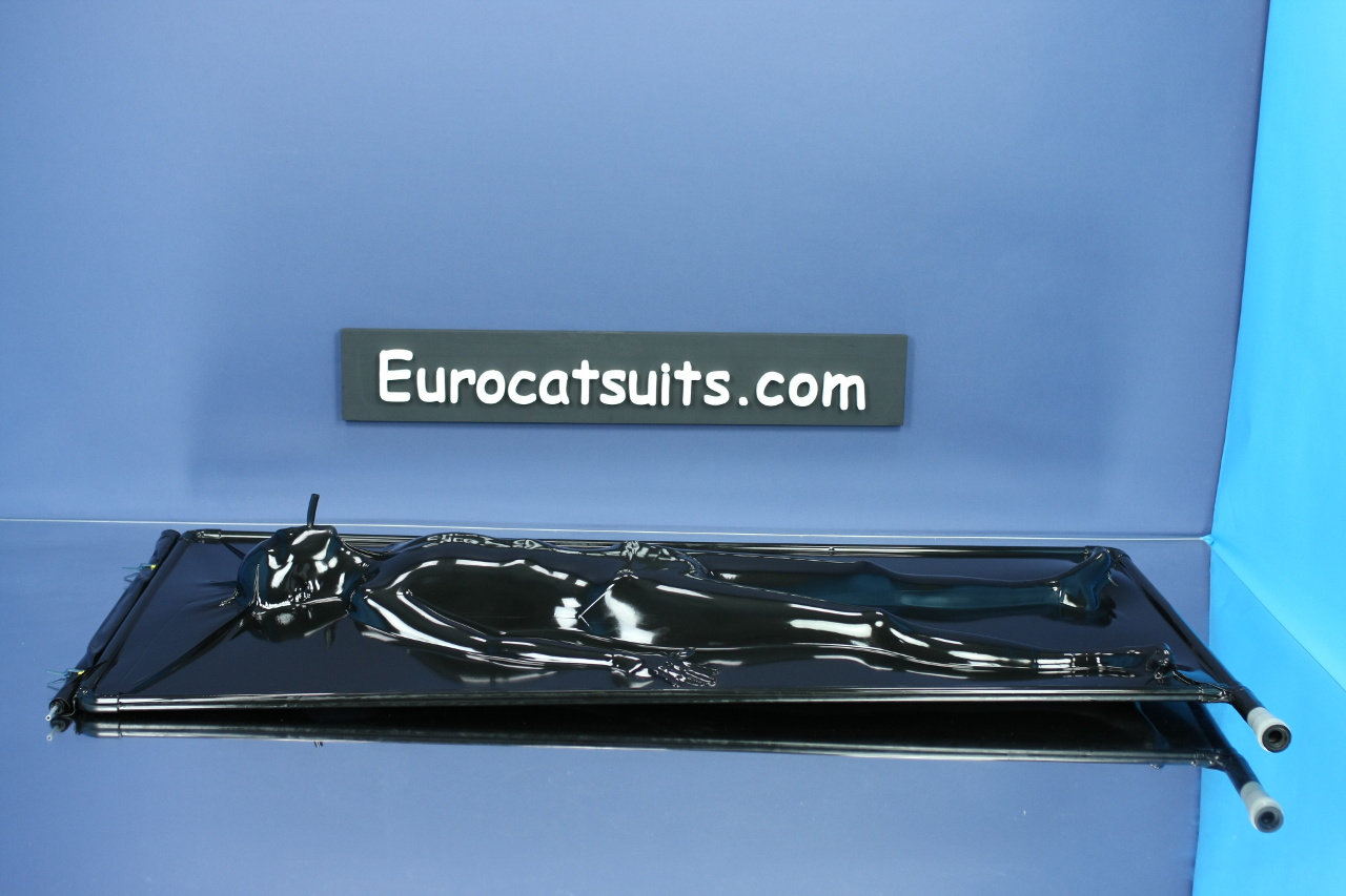 black latex vacbed / vakuumbett with attached breathing hose and stainless steel frame . This vacuumbed creates very strong bondage . Because its airtight , you can enjoy it without noise of running vacuumcleaner . Click to see full resolution image.