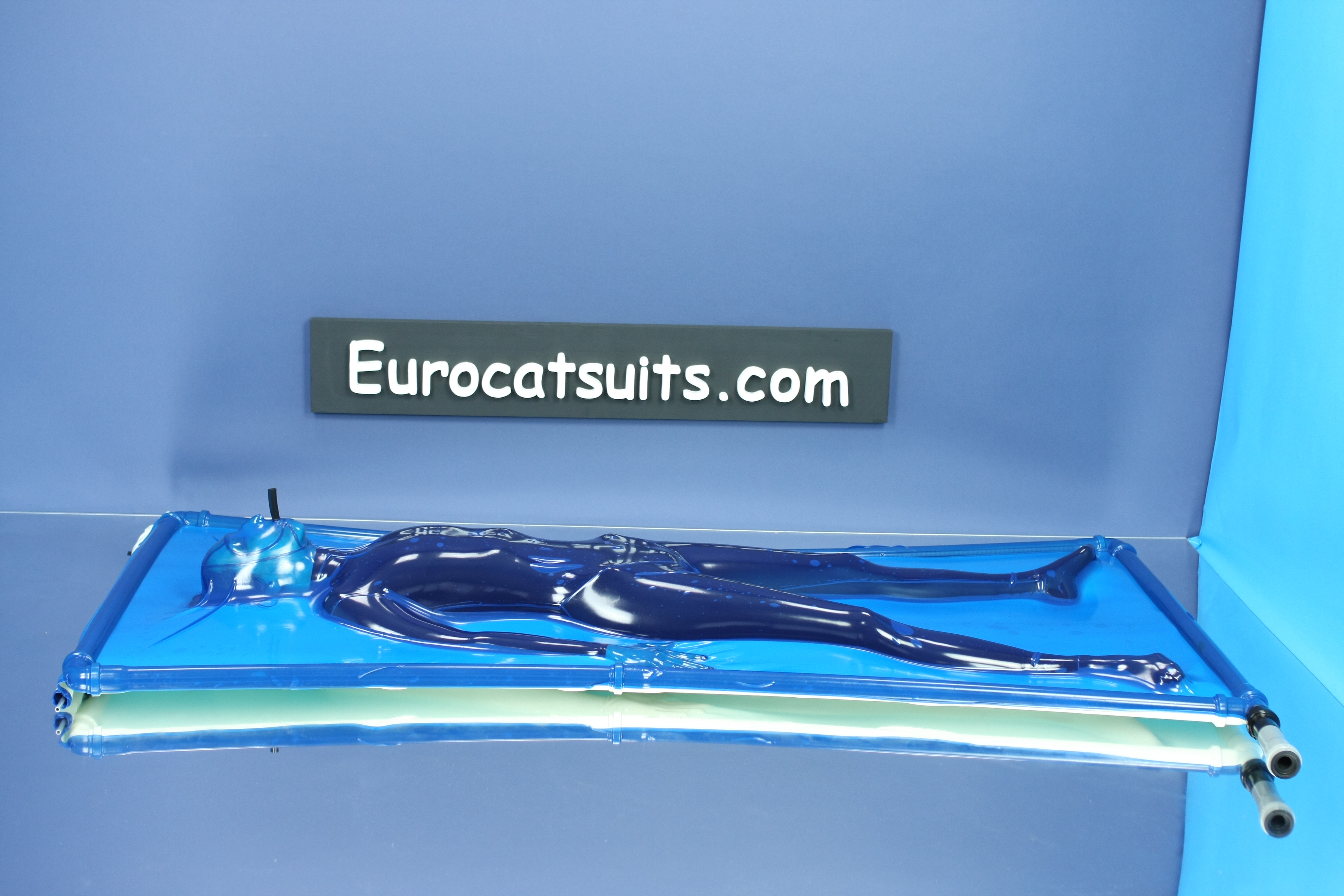 blue latex vacbed / vakuumbett with attached made to measure face and breathing hose and standard plastic frame. This vacuumbed creates very strong bondage . Because its airtight , you can enjoy it without noise of running vacuumcleaner
