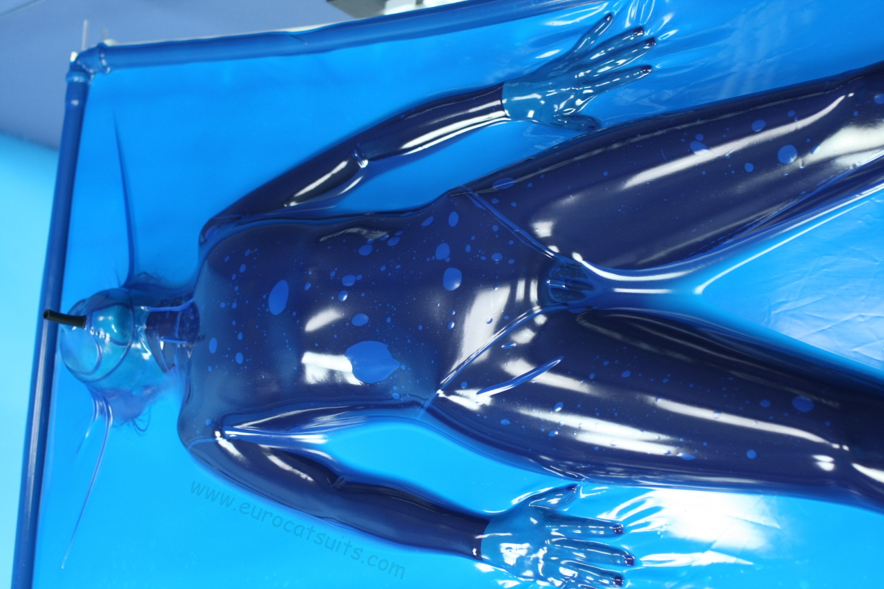 blue latex vacbed / vakuumbett with attached made to measure face and breathing hose and standard plastic frame ( stainless steel frame optional ). This vacuumbed creates very strong bondage . Because its airtight , you can enjoy it without noise of running vacuumcleaner . Click to see full resolution image.