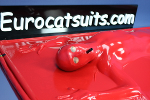 Attached made to measure latex mask in red 0.4mm latex , equipped with transparent latex lens and attached breathing hose . The vacbed remains totally airtight .